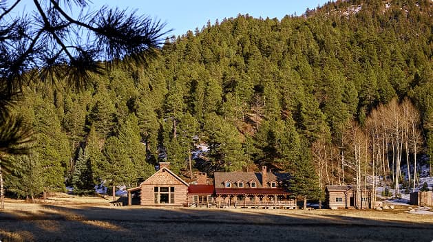 Secluded mountain lodge surrounded by evergreen forests and alpine scenery, offering a private wilderness retreat at Trinchera Reserve & Lodge.